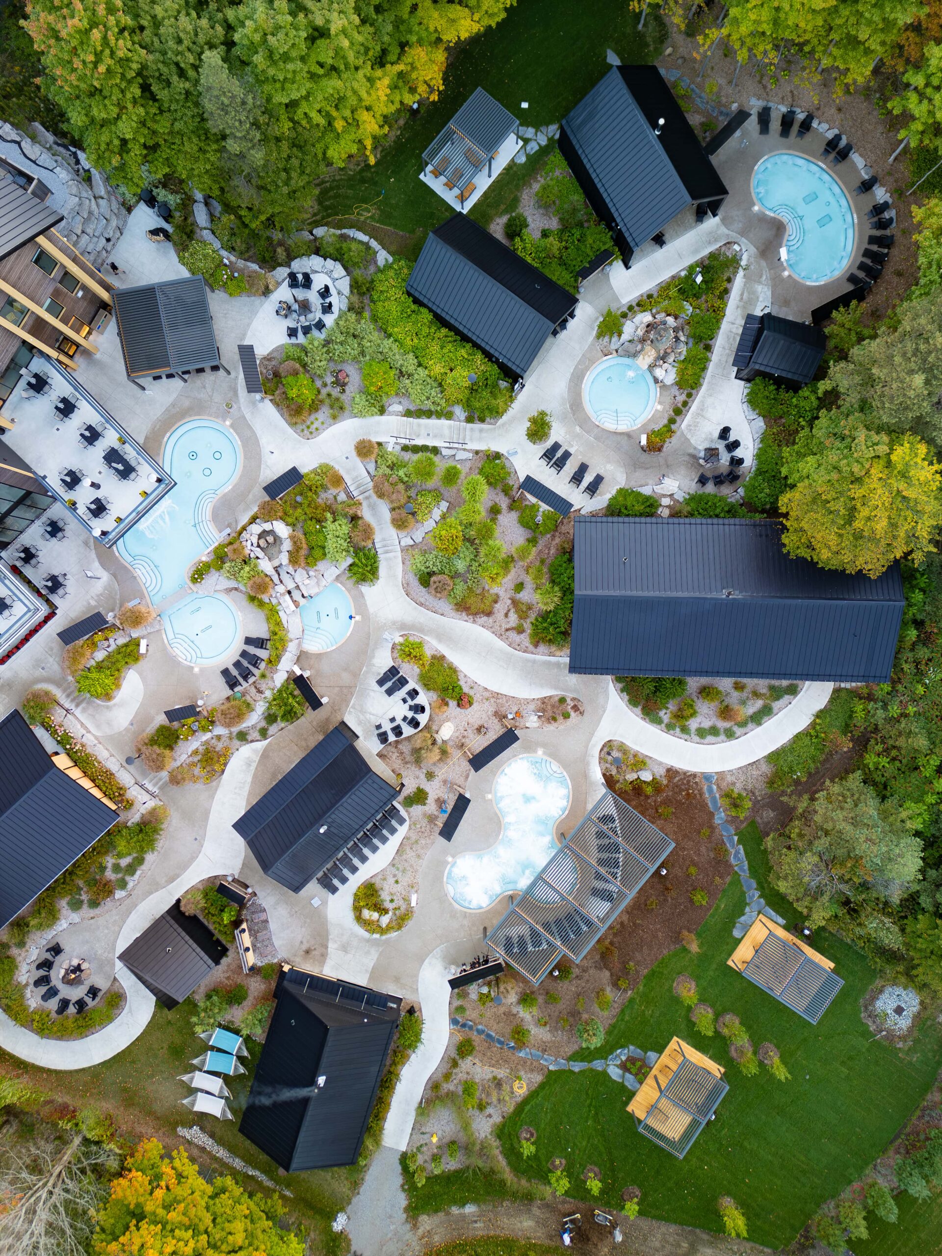 Black louvered aluminum pergola for commercial spa and pool area in Vancouver